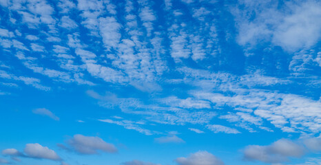 Obraz premium White clouds on blue sky. Beautiful sunny sky. Background with clouds on blue sky. Clouds on sky design.