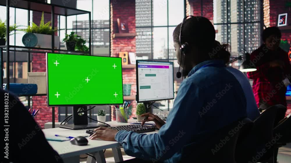 Poster technical support specialist in call center office doing troubleshooting using green screen computer