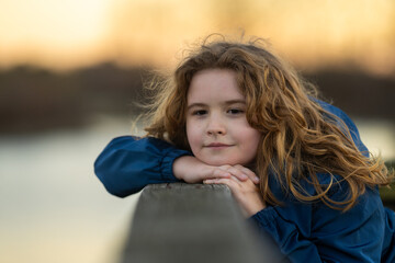 Childhood. Blonde kid dreams. Child thoughtful expression. Little thinker enjoying a carefree day. Happy kid portrait. Dreams in a child eyes. Quiet moment of childhood imagination.