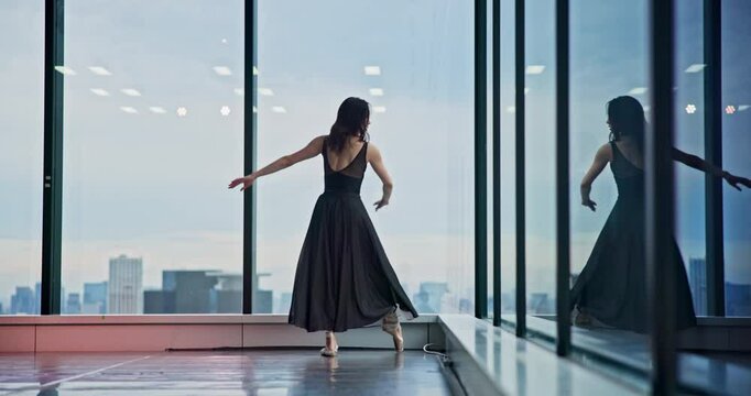 Woman, ballet and dancing at window with performance, elegance or talent audition. Japanese dancer, movement and creative in studio with artistic expression, routine rehearsal or culture choreography