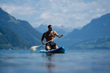 Sexy summer man. Muscular body. Hot summer. Man swimming in lake. Nude male body. Guy splash in...