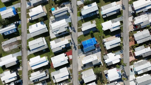 Aerial top down of dense populated houses and and trailer homes in RV Park of Florida. Sunny day with small buildings in Bradenton City.