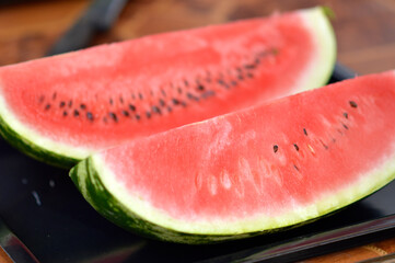 slices of ripe red watermelon at the table