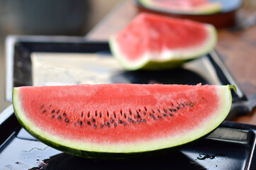 slices of ripe red watermelon at the table