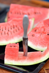 slices of ripe red watermelon at the table
