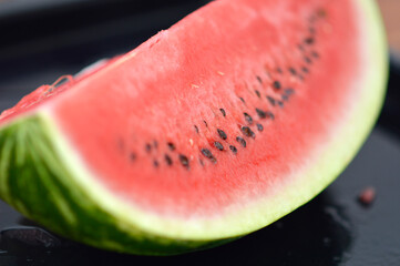 slices of ripe red watermelon at the table