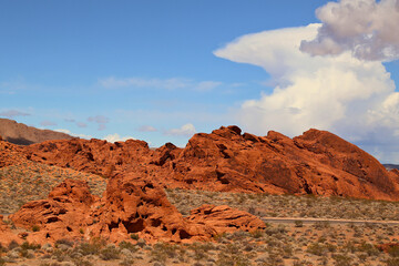 A scenic view of red rock mountains and blue sky