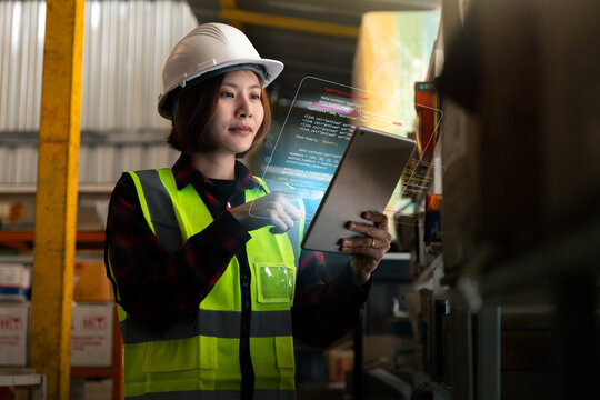 Engineer woman wearing a safety vest and a hard hat is working with tablet cybersecurity - Powered by Adobe