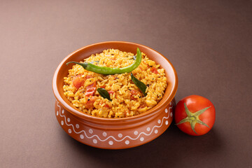 Indian Traditional Tomato rice with vegetables serve in bowl isolated on dark background 