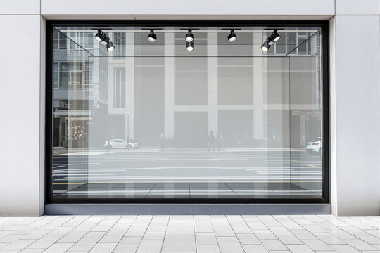 Blank storefront window mockup with reflections of city street.