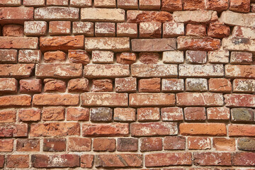 Old red brick wall background, uneven brickwork texture