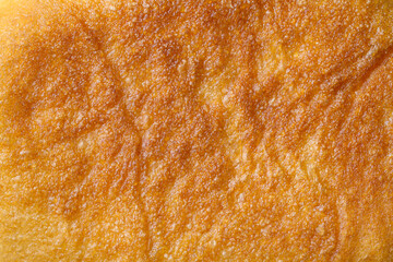 Surface texture of fried baked goods. Close-up of the surface of the pie.