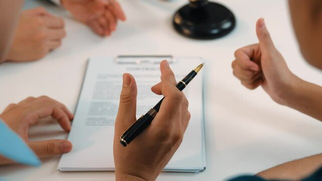 Couples legal file for divorcing by assistance from law firm to divide property after breakup. Obligations contract assist by lawyer in negotiating settlement agreement meeting. Slow motion. Rigid.