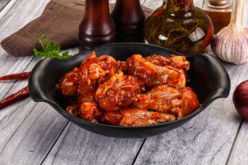 Raw marinated buffalo chicken wings
