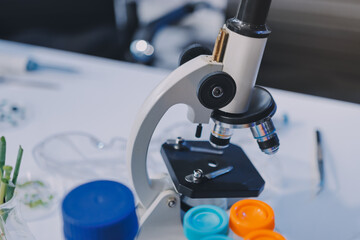 Team Asian scientists in a lab conducting food research using a microscope and lab equipment,...