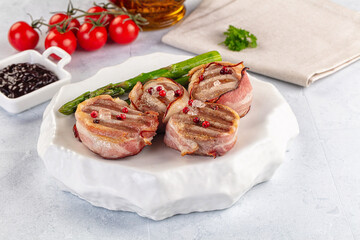 Tasty grilled pork medallion with bacon