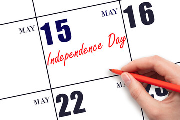 May 15. Hand writing text Independence Day on calendar date. Save the date. Holiday. Planning or...