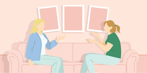 two women sitting on a couch engaging in a calm conversation