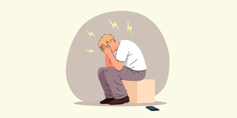 young man sits alone in hands showing signs of stress and emotional distress.