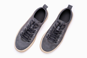 Gray sneakers on white background close-up, top view.