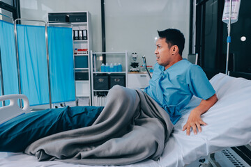 Lonely man silhouette sitting on the bed feeling depressed and stressed in the dark bedroom, Depression and anxiety disorder concept