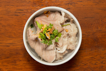 Savory pork bowl local eatery food photography rustic setting close-up culinary delight