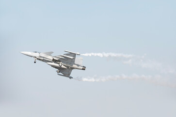 Fighter plane on blue sky background behind technology