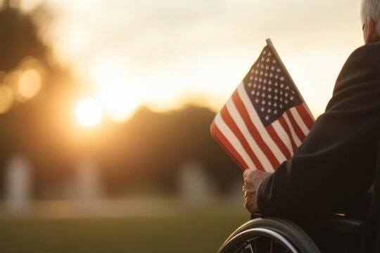 Sunset casts warm light on veteran holding an American flag in r