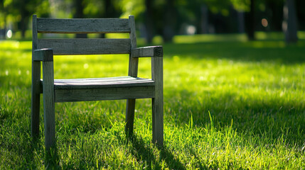 Fototapeta premium Charming Timeworn Wooden Chair in a Serene Public Park Scene Surrounded by Lush Green Grass