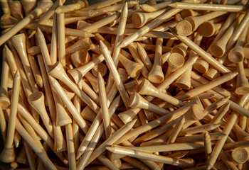 Close up of a pile of brown golf tees