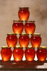 Jars of fresh flower honey on the table