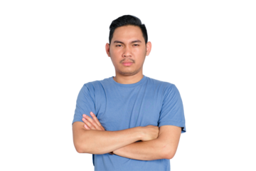 Serious young man with crossed arms, looking at camera, isolated on transparent background