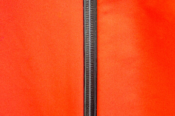 Orange outdoor membrane jacket with zipper close-up  © Mikhail Taratonov