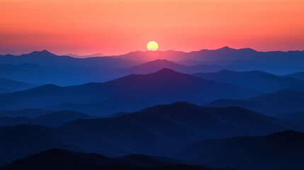 Fototapeta premium A serene sunset over layered mountains, showcasing nature's beauty and tranquility.