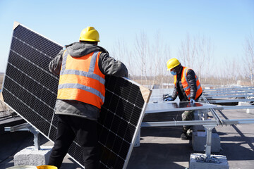 Workers install solar photovoltaic panels