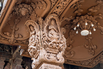 The intricate wooden architecture of the Temple of Truth in Pattaya,Thailand.The temple features ornate carving and statues,with a detailed root structure and multiple spires.outside view