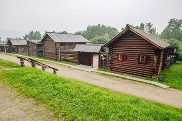Obraz premium Weathered wooden houses showcasing traditional russian architectural style standing in historic open air museum preserving cultural legacy