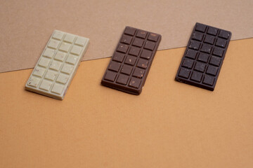 Multicolored chocolate bars placed on a light background. Healthy eating concept, delicious...