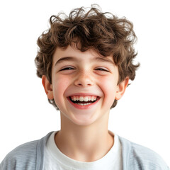 A cheerful young boy with curly brown hair is smiling broadly showing his teeth on a black background