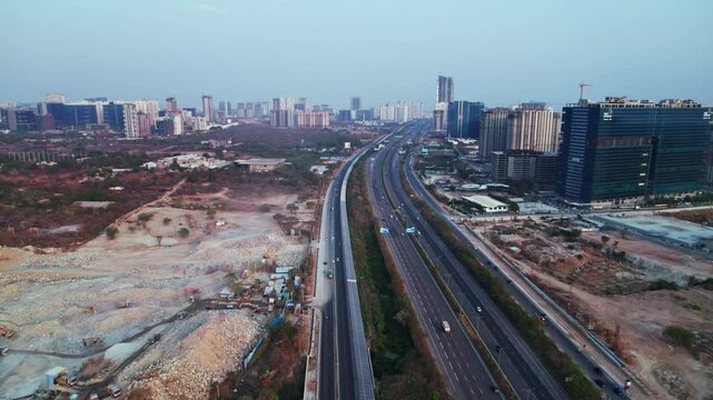 concrete mining with under construction buildings and outer ring road at financial district, Nanakramguda, hyderabad, india. day time, push in, drone shot, 4k.