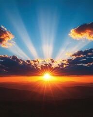 Fototapeta premium A breathtaking sunset with vibrant rays of light streaming through colorful clouds over a mountainous landscape.