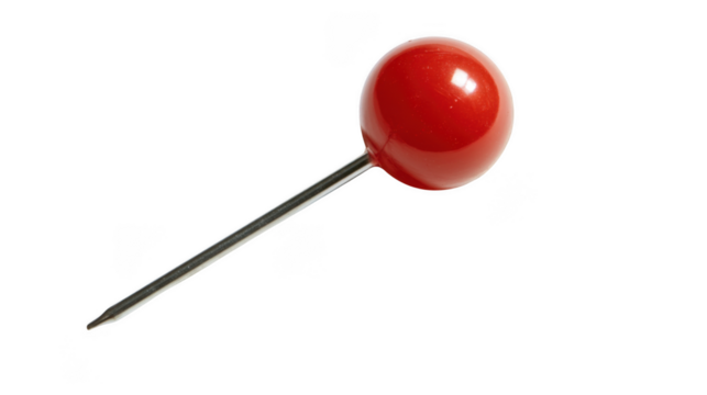 A close up shot of a red push pin with a silver needle on a black background in a studio setting