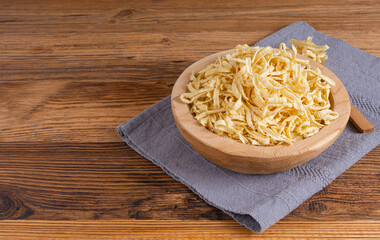 Passatelli spatzle pasta in bowl, raw spaetzle noodles, dry homemade german macaroni