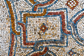 Background with a fragment of an ancient decorative mosaic on the floor of ruined church