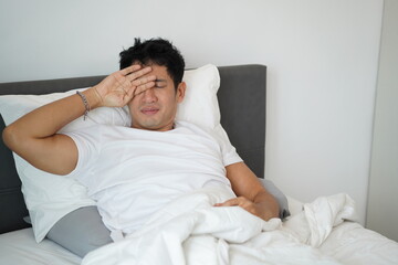 Man rubbing eyes with tired expression