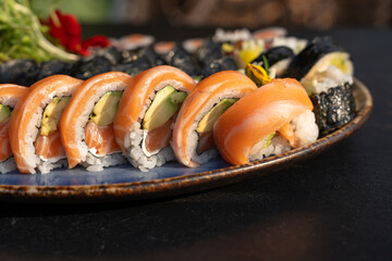 Sushi platter with assorted rolls salmon, tuna, cucumber, avocado, seaweed, rice, tempura