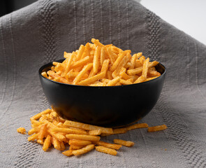 Fried chips sticks, finger potato chips, golden shoestring fries pile, French fries