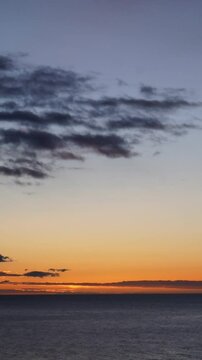 Time-lapse of a sunrise at sea in vertical format