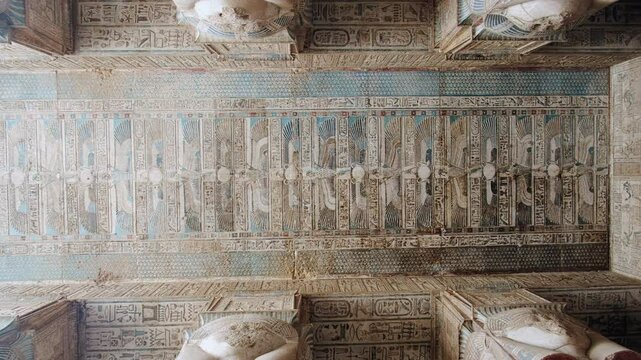 Ceiling of Hypostyle Hall decorated with hieroglyphics and ancient egyptian theme pictures. Temple of Hathor. Dendera Temple complex, Qena, Egypt