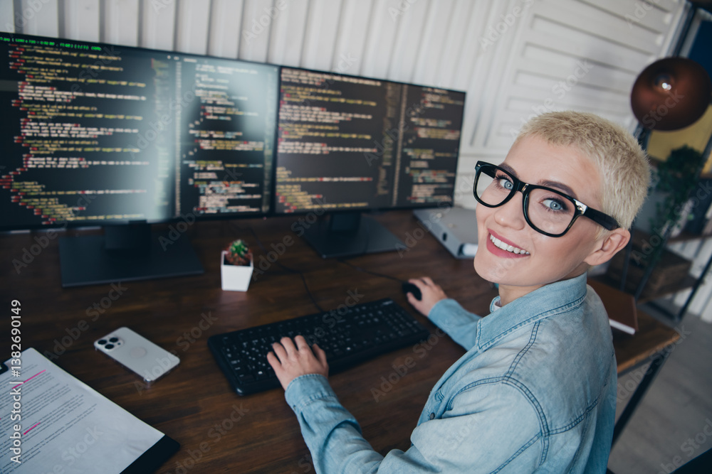 Wall mural young casual female coder working on digital solutions with confidence